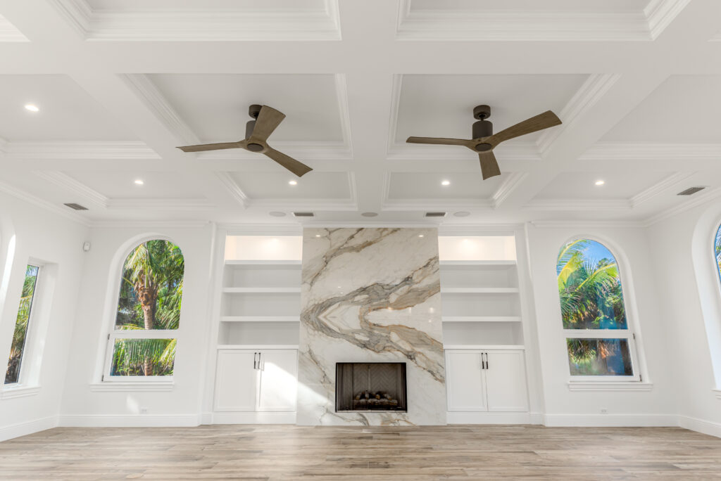 Warm neutral living room with layered linen, wood, and grasscloth by Florida Interior Designer Tracie Annase