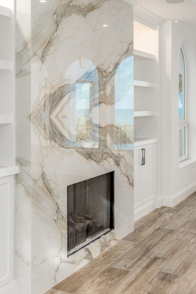 Dramatic veined quartzite fireplace in coastal home by Florida Interior Designer Tracie Annase